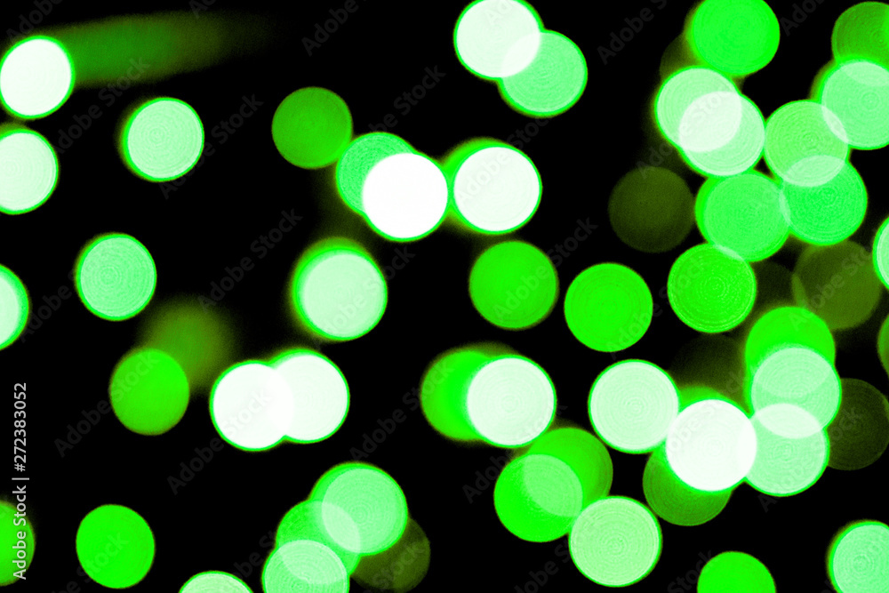 Obraz premium Unfocused abstract colourful bokeh black background. defocused and blurred many round green light