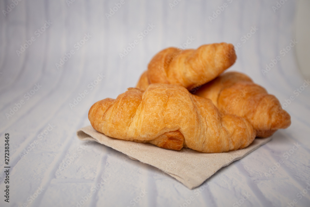 Croissants with coffee cups with flour and eggs on a white background, breakfast, brown bread, morning drinks, fantasy world: delicious food for health, pastries, bakery, restaurants, lifestyle areas
