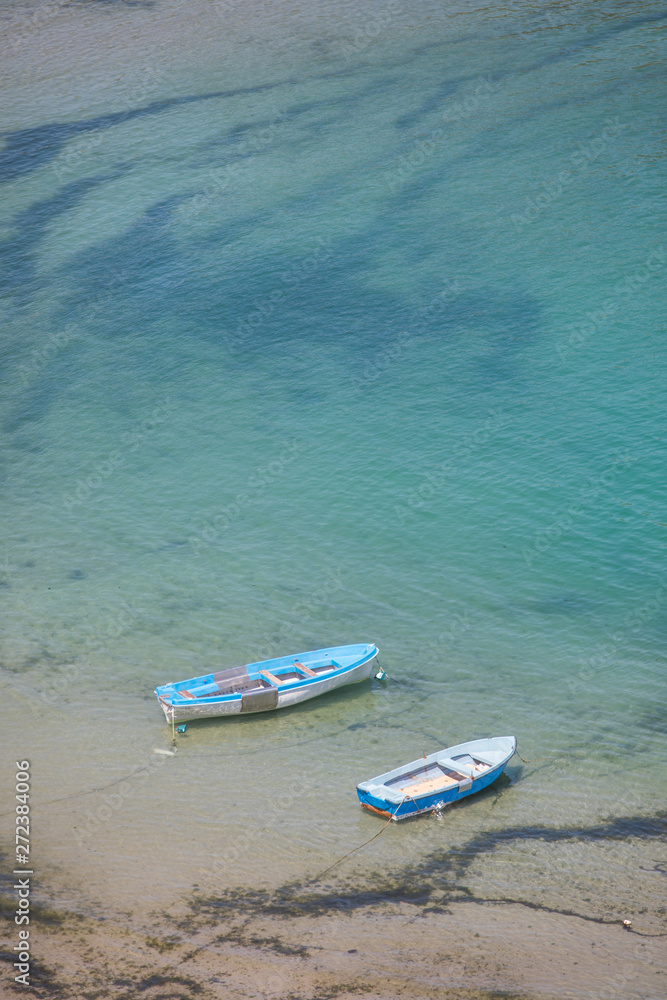 Two boats floating on blue water