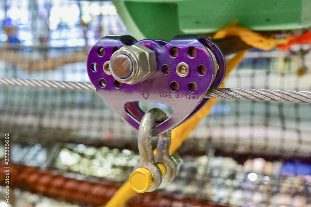 purple roller for the movement of equipment on the steel cable. close up obstacle course element