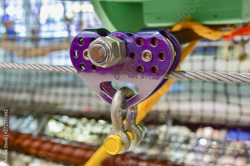 Obraz na płótnie purple roller for the movement of equipment on the steel cable. close up obstacle course element w salonie