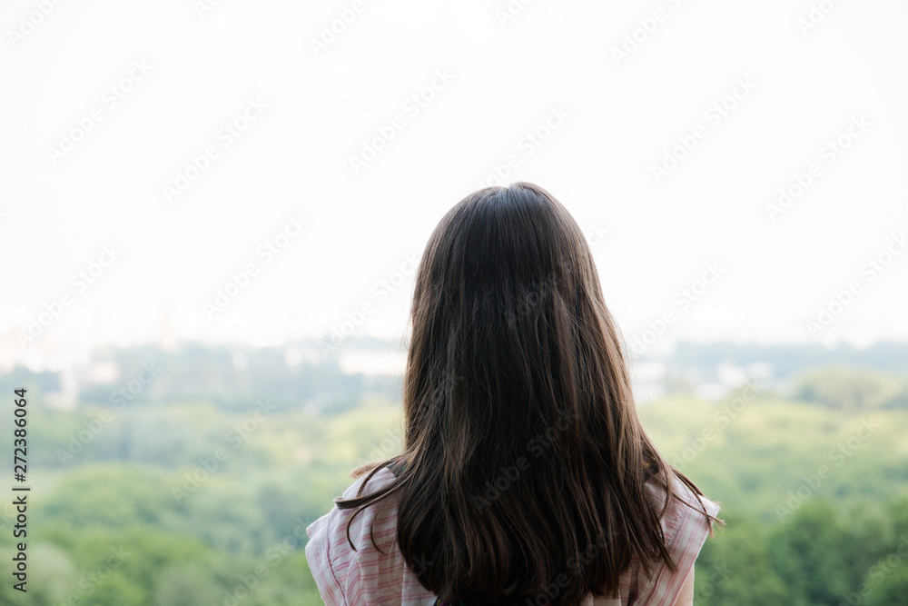 Young girl traveller while enjoying the amazing views of the city, walking and exploring nature . Expectation. Young girl traveller while enjoying the amazing views of the city, walking and exploring nature . Expectation.