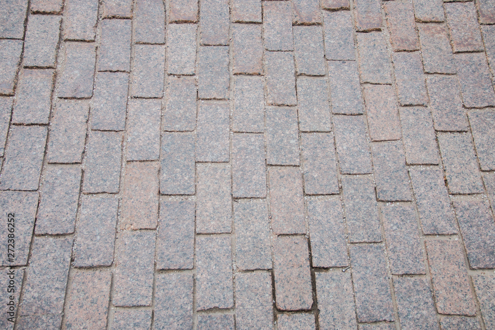 Sand-colored bricks. Stone pavement on the ground for street road. Sidewalk, driveway, cobblestones, sidewalk square pattern. textured background