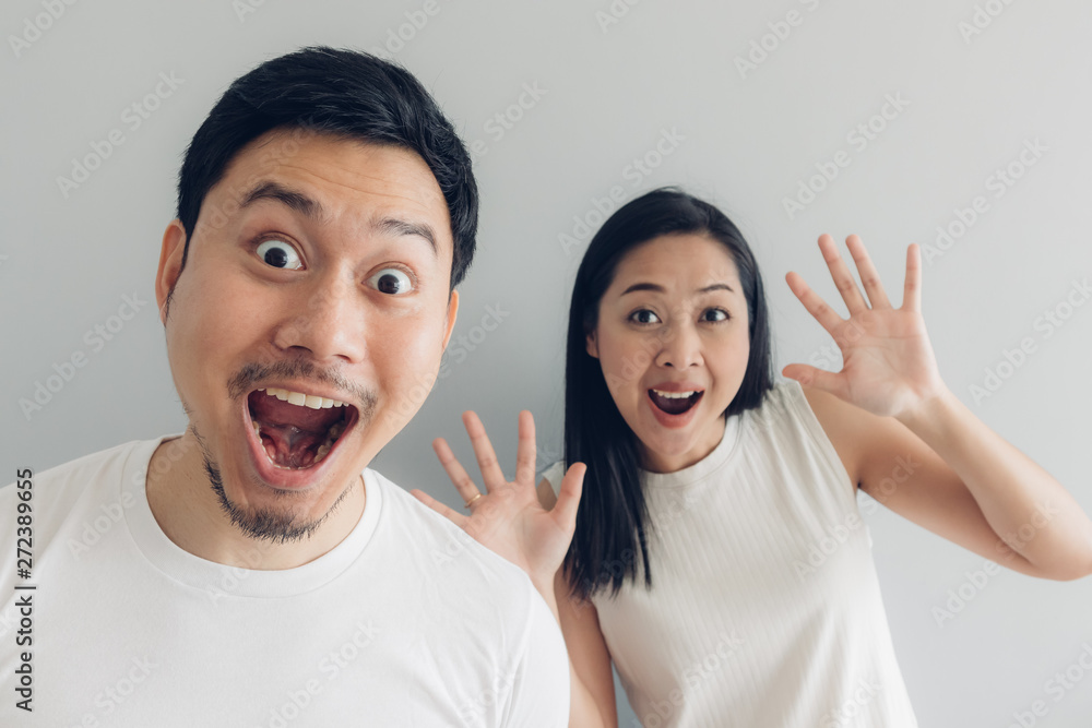 Surprised and shocked couple lover in white t-shirt and grey background. Surprised and shocked couple lover in white t-shirt and grey background.