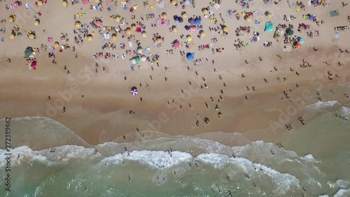 Crowded public beach with colourful umbrellas,  Aerial footage. photo