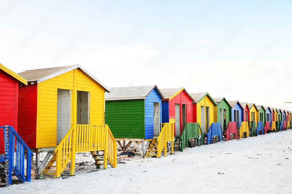 Naklejka premium Multicolored beach huts on Muizenberg beach, Cape Town, South Africa