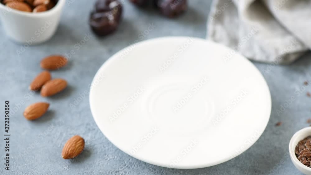 Stop motion animation of vegain protein chocolate truffles with dates, seeds and nuts. Concept of healthy eating, healthy lifestyle, dieting, weight loss Stop motion animation of vegain protein chocolate truffles with dates, seeds and nuts. Concept of healthy eating, healthy lifestyle, dieting, weight loss