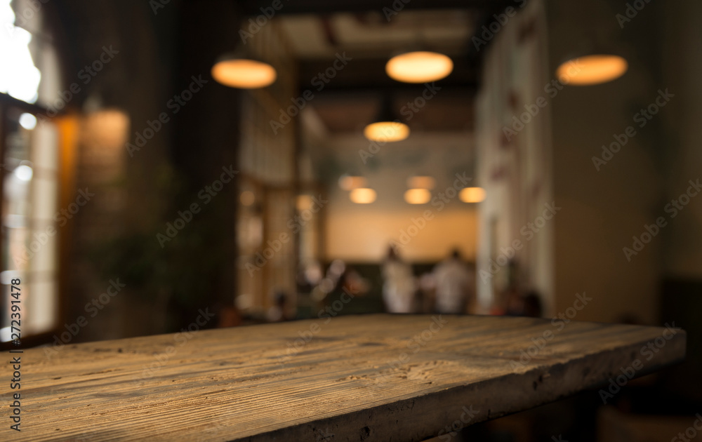 image of wooden table in front of abstract blurred background of resturant lights image of wooden table in front of abstract blurred background of resturant lights