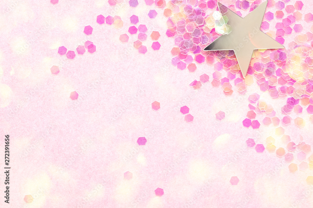 Confetti and silver stars on a pink background, festive concept.