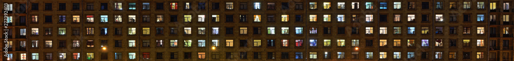 Panorama of the night Windows of the city apartment building