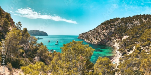 View from above of the beautiful Cala Blanca, Andratx with a turquoise waters and spanish nature landscape with blue bright summer sky. Mallorca, Balearic Islands