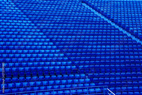 Empty blue seats in stand of the soccer stadium.