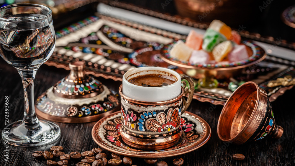 Fototapeta premium The concept of Turkish cuisine. Turkish brewed black coffee. Beautiful coffee serving in the restaurant. Background image. copy space