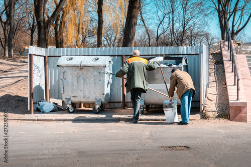 garbage collection. public service. workers tidying up in the yard.