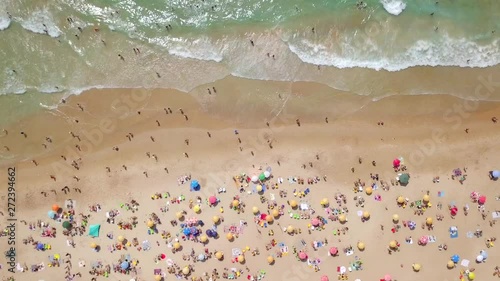 Crowded public beach with colourful umbrellas,  Aerial footage. photo