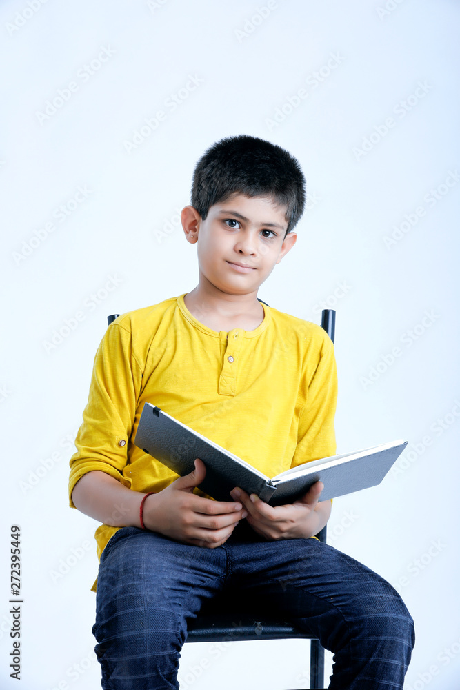 young indin boy holding a notebook young indin boy holding a notebook