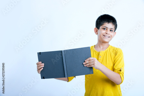 young indin boy holding a notebook  photo