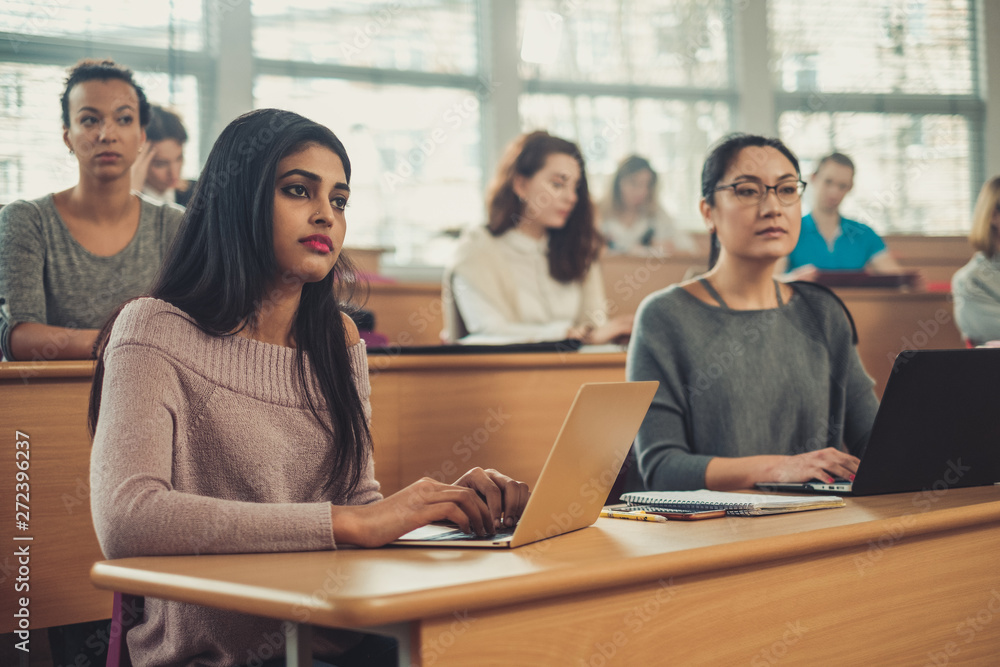Multinational group of students in an auditorium Multinational group of students in an auditorium