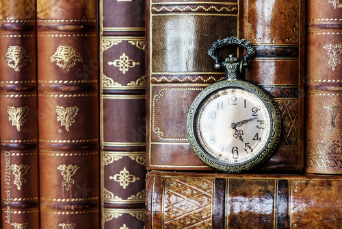Pocket watch and old books