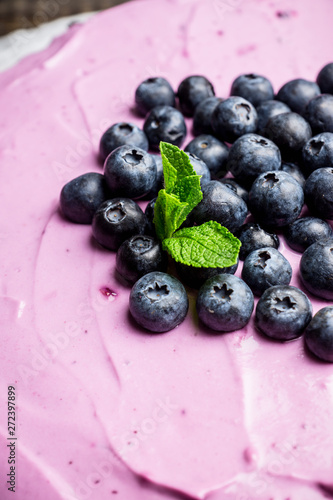 Fresh blueberry cheesecake on the rustic background. Selective focus. Shallow depth of field.