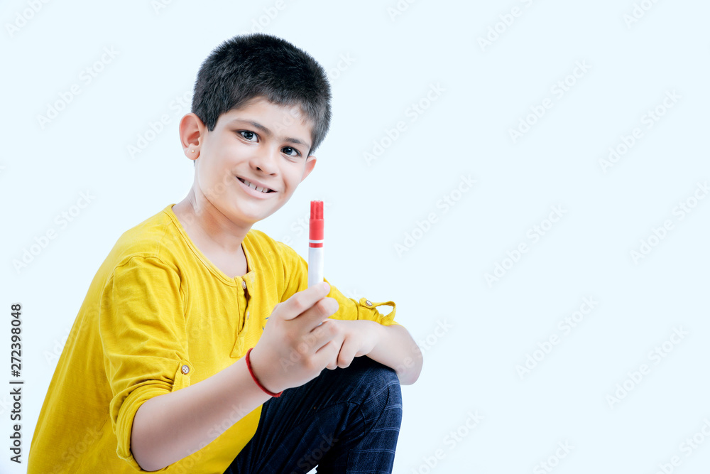 young indian child showing a pen, marker young indian child showing a pen, marker