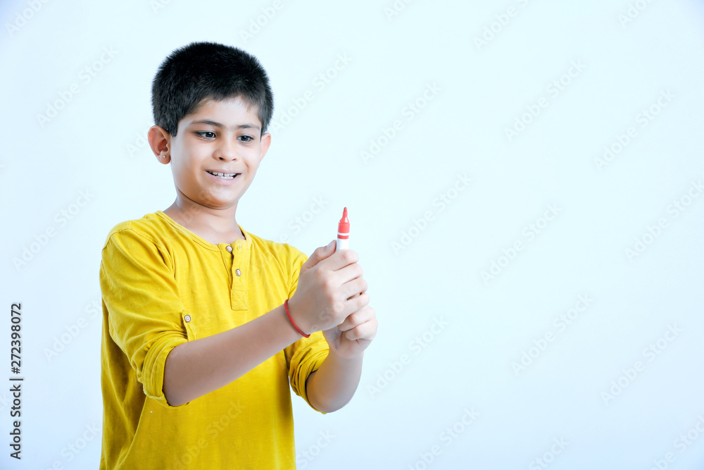 young indian child showing a pen, marker young indian child showing a pen, marker