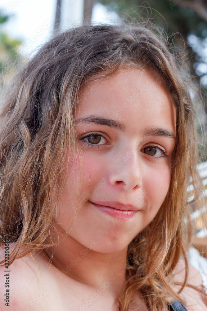 Portrait of a pretty teenager girl with long curly hair Portrait of a pretty teenager girl with long curly hair