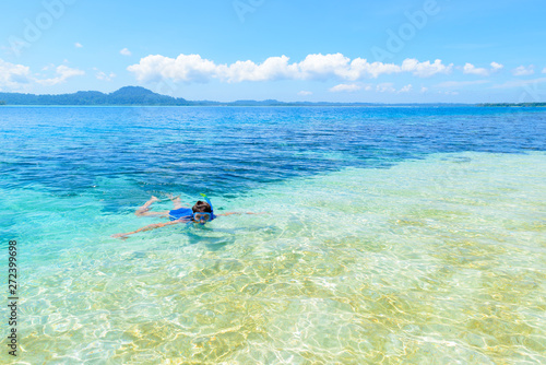 Woman snorkeling in caribbean sea, turquoise blue water, tropical island. Indonesia Banyak Islands Sumatra, tourist diving travel destination.