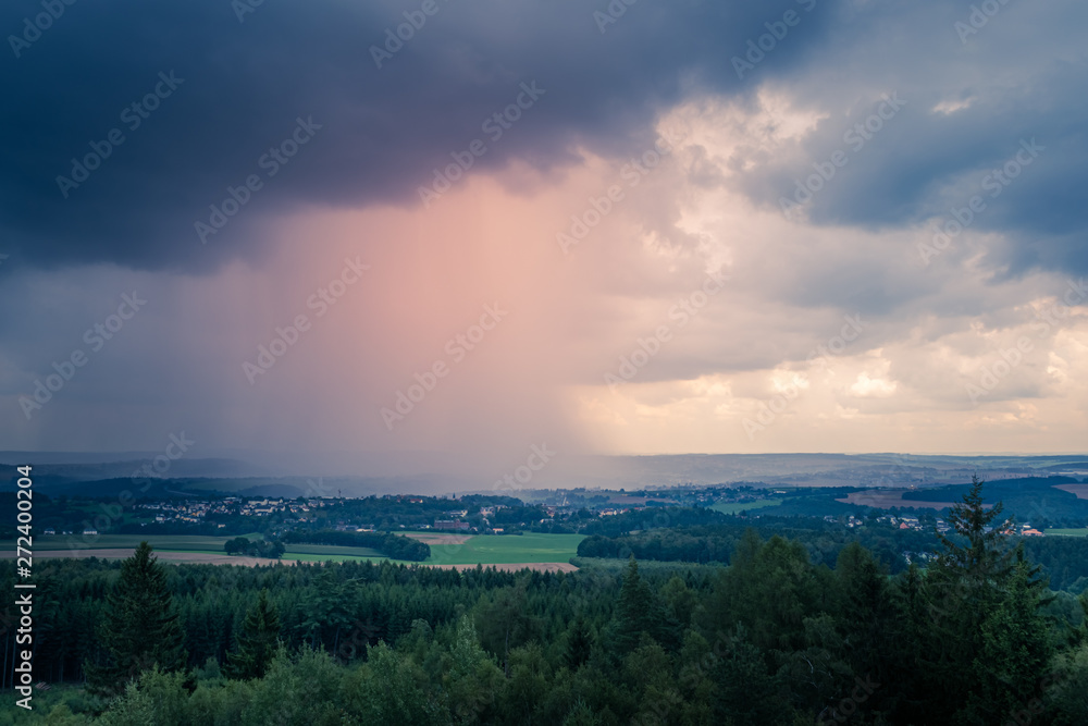 Stormy evening weather over rolling hills