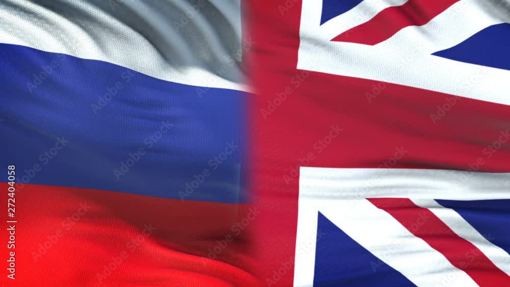 Russia and GB officials exchanging confidential envelope, flags background Russia and GB officials exchanging confidential envelope, flags background