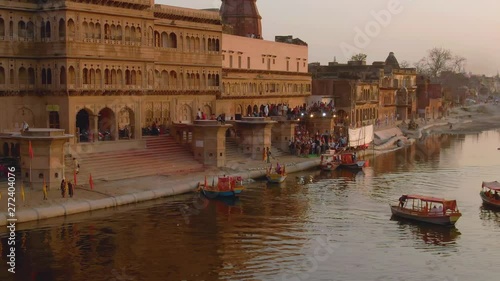 Ganga river ghat with boats in India, Vrindavan, 4k aerial drone sunset photo