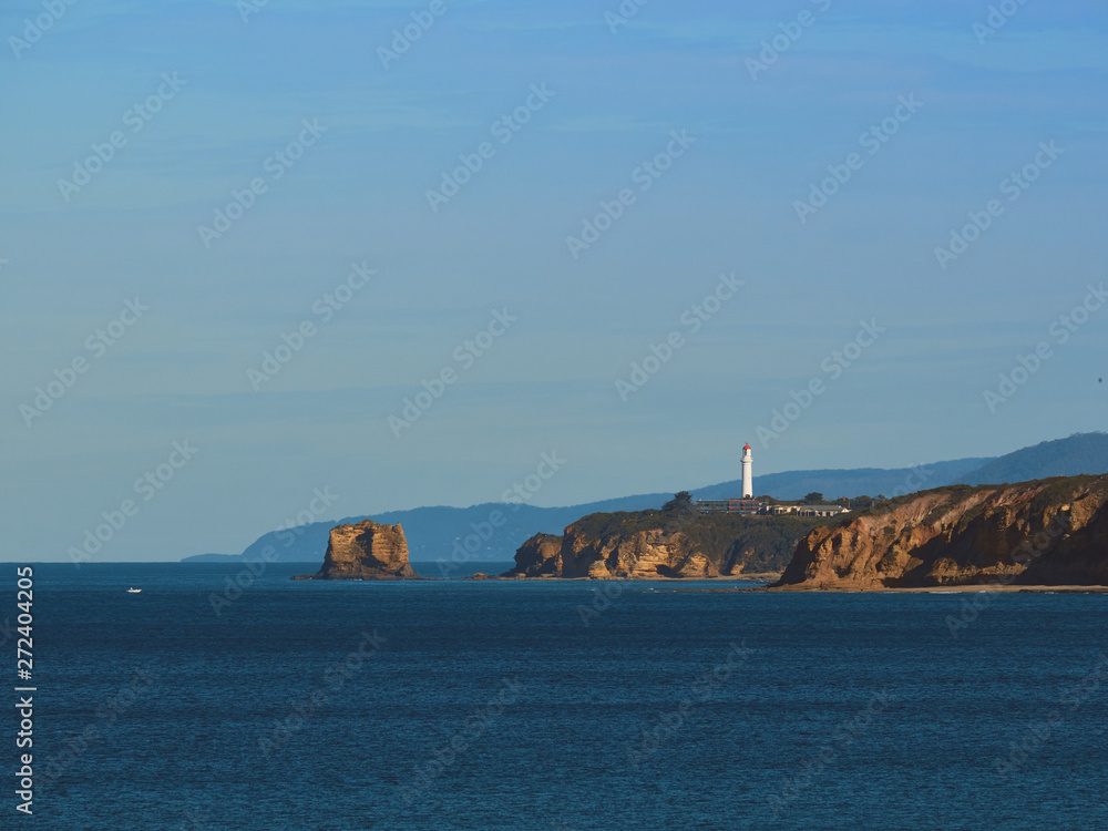 Lighthouse next to ocean
