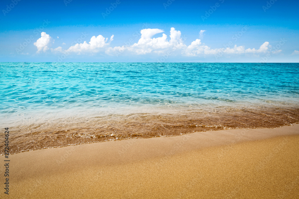Summer background of sea with sand and blue sky. Free space for your decoration. 
