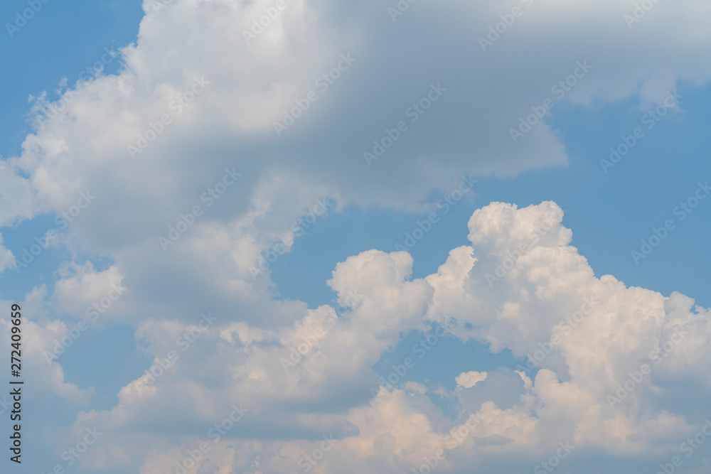 White clouds in the blue sky. Atmospheric phenomenon.