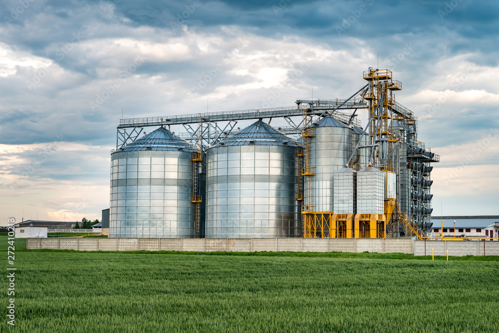 agro-processing plant for processing and silos for drying cleaning and storage of agricultural products, flour, cereals and grain with beautiful clouds