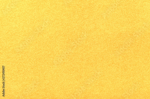 Light yellow matt suede fabric closeup. Velvet texture of felt.