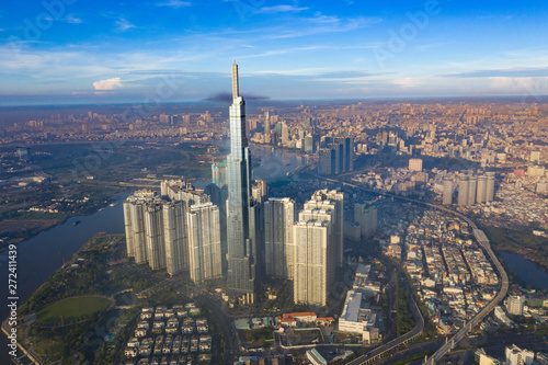Fototapeta Naklejka Na Ścianę i Meble -  Top View of Building in a City - Aerial view Skyscrapers flying by drone of Ho Chi Mi City with development buildings, transportation, energy power infrastructure. include Landmark 81 building 