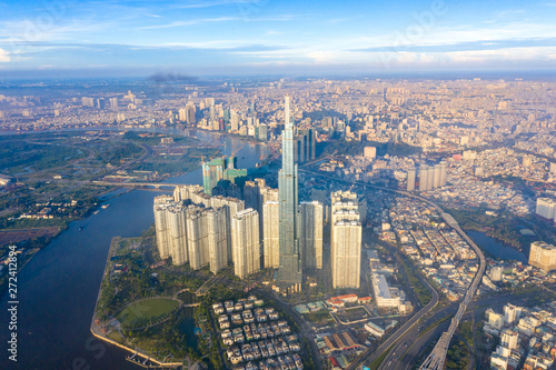 Fototapeta Naklejka Na Ścianę i Meble -  Top View of Building in a City - Aerial view Skyscrapers flying by drone of Ho Chi Mi City with development buildings, transportation, energy power infrastructure. include Landmark 81 building 