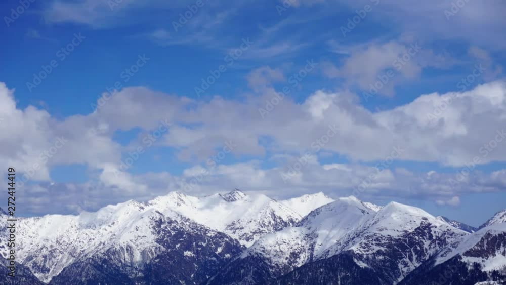 White clouds flying high over Caucasus mountain landscape fade-in. Can be used for opening credits, titles. Time lapse. White clouds flying high over Caucasus mountain landscape fade-in. Can be used for opening credits, titles. Time lapse.