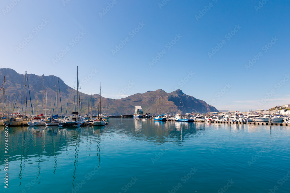 Hout Bay boats and mountain reflections morning view