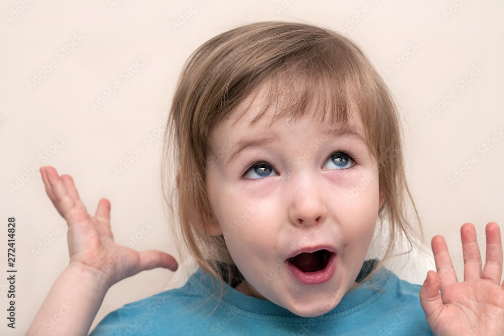 funny admiration emotional white child girl face closeup on beige wall background funny admiration emotional white child girl face closeup on beige wall background