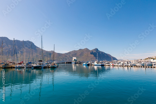 Hout Bay boats and mountain reflections morning view photo