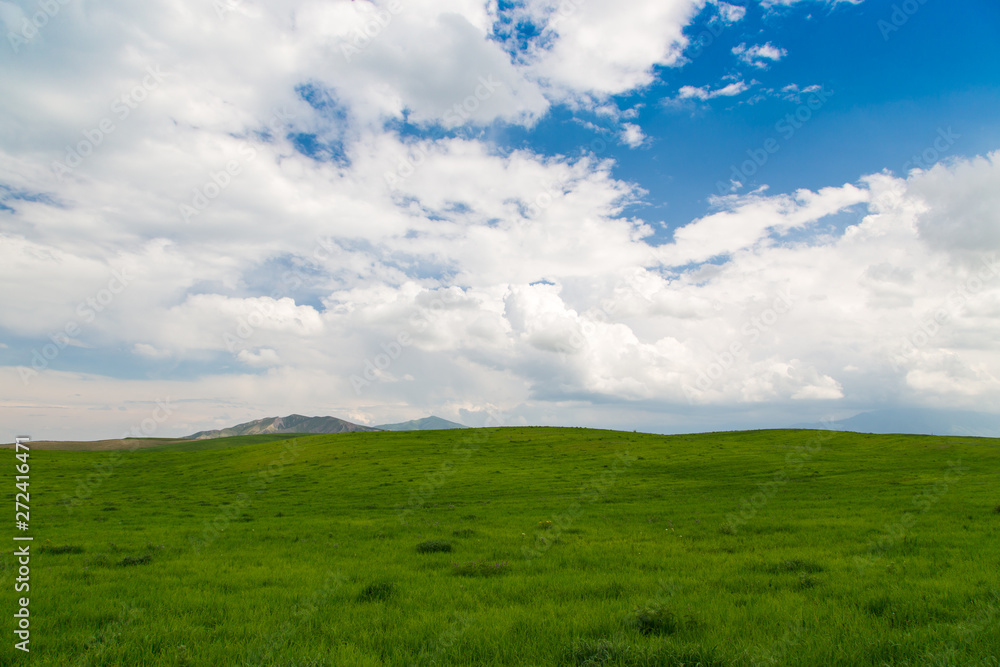 Beautiful spring and summer landscape. Lush green hills, high mountains. Summer natural background. Beautiful spring and summer landscape. Lush green hills, high mountains. Summer natural background.