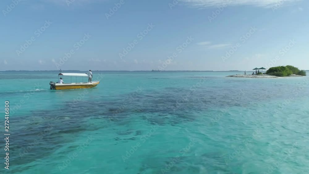 Pan around small boat traveling over crystal clear waters of Maldives reef 4k Pan around small boat traveling over crystal clear waters of Maldives reef 4k