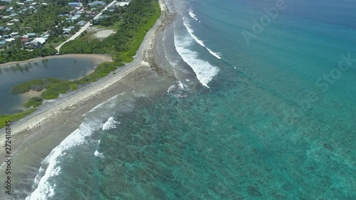 Waves on the beach of Gan Island, aerial revealing shot of Maldives Addu Atoll 4k photo