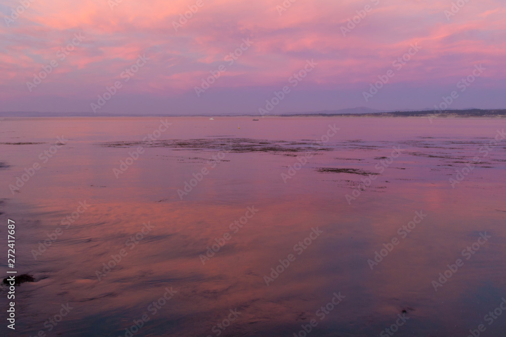 Amazing pink sunset over the bay in Monterey, California