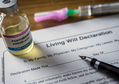 Living will declaration form Next to a vial of pentobarbital sodium to proceed to euthanasia, conceptual image photo