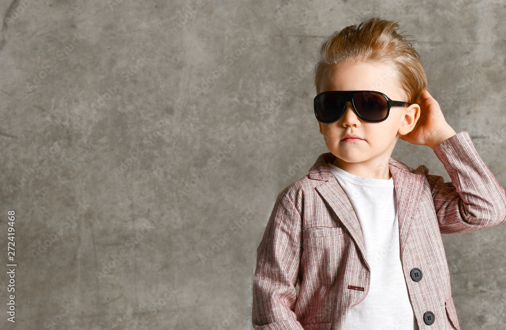 Image of cheerful excited little boy child standing isolated over concrete wall. Image of cheerful excited little boy child standing isolated over concrete wall.