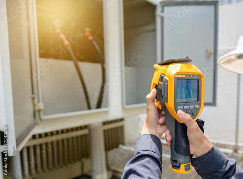 Technician use the thermoscan to check temperature in transformer