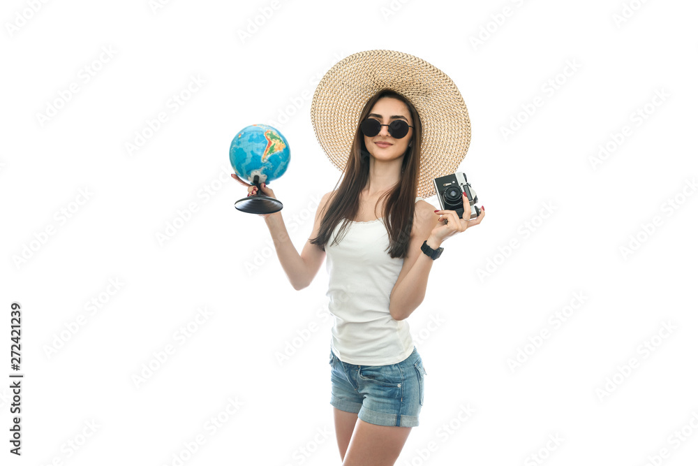 Young woman in hat holding globe and camera Young woman in hat holding globe and camera
